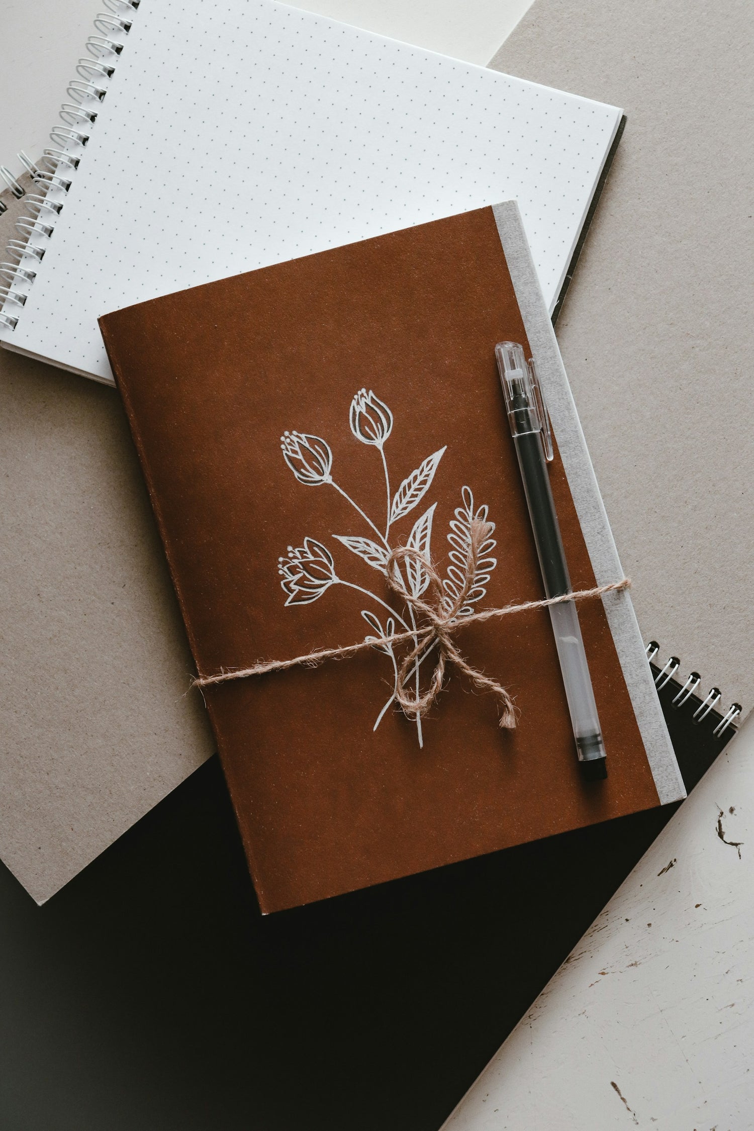 A beautiful, handcrafted leather journal with a ball pen